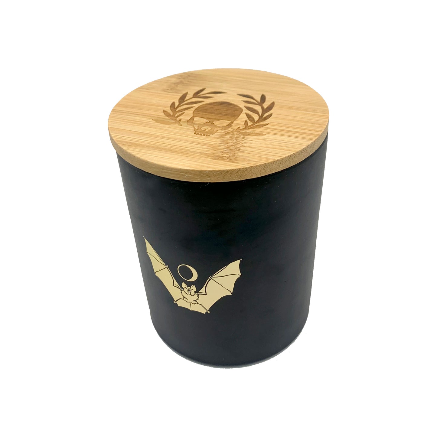 soy wax candle with matte black base and gold foil design of bat and crescent moon. T'erre de hermes scent. Pumpkin and tarot cards in background.