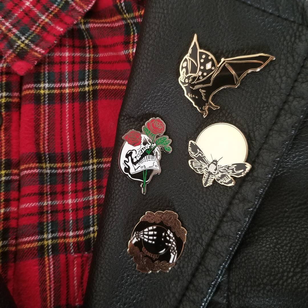 hard enamel pin of death-head moth designed by Amrit Brar on leather jacket collar