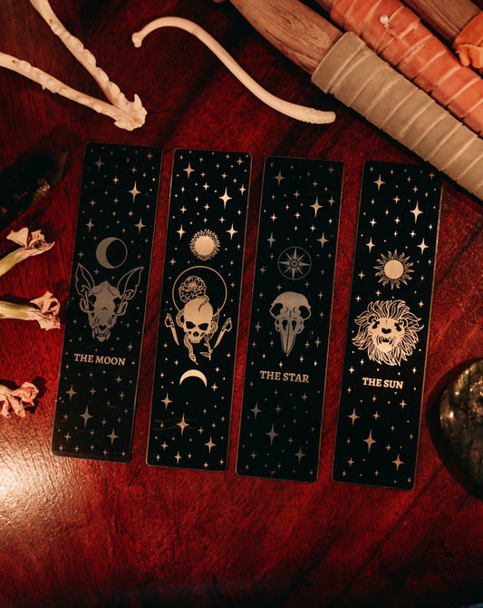 Bookmark bundle with the Star, Sun, Moon, Marigold Night designs from Marigold Tarot deck by Amrit Brar and 13th Press. Black, gold, and silver metal.