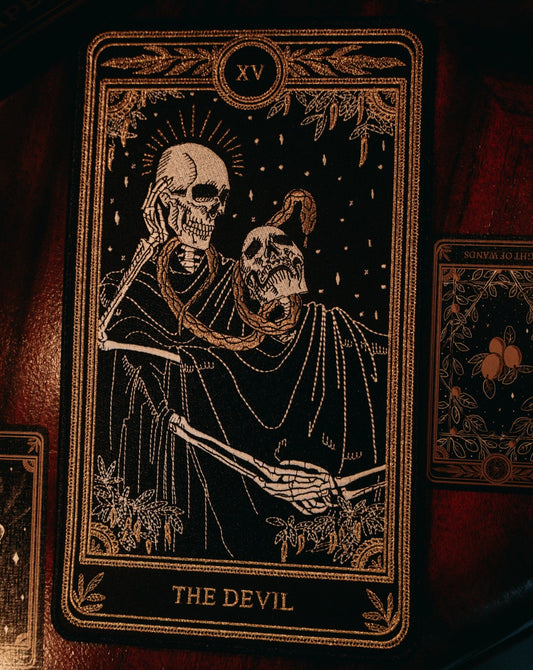 the devil tarot embroidered patch with black, gold, and white thread design from the Marigold Tarot deck by Amrit Brar and 13th Press