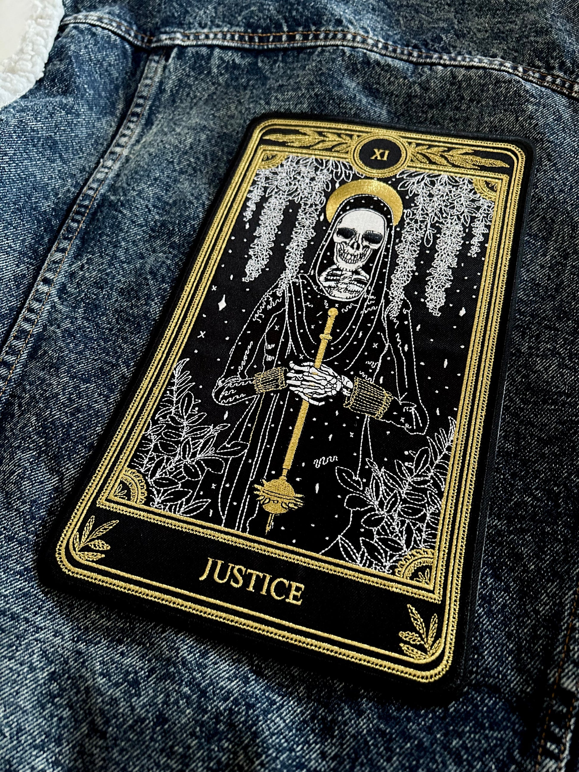 large embroidered iron-on back patch with justice tarot card design from the marigold tarot deck