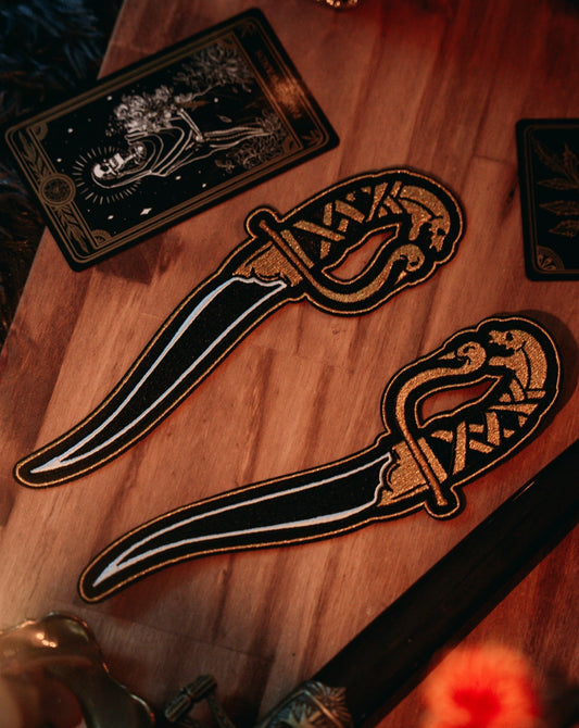 embroidered dagger gold and black thread iron-on patches designed by amrit brar and 13th press