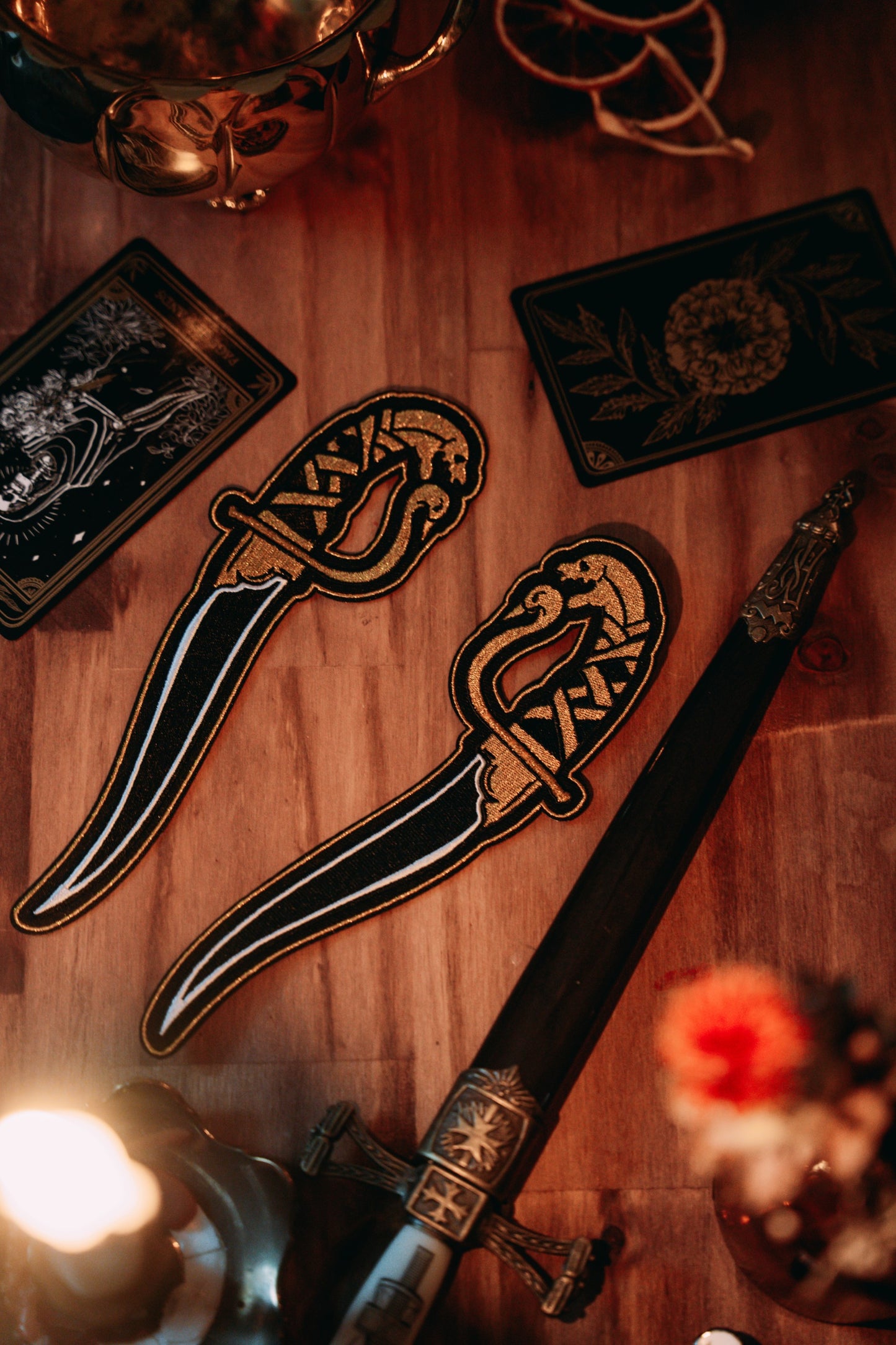 embroidered dagger gold and black thread iron-on patches designed by amrit brar and 13th press