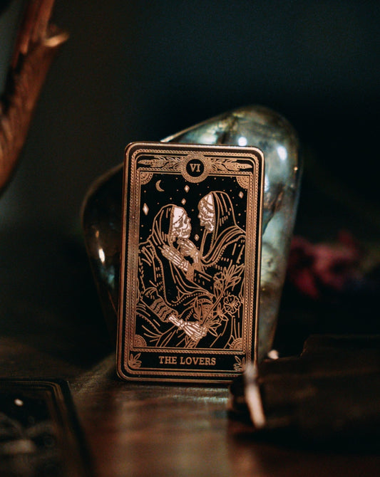 the lovers black, gold, and white metal hard enamel pin design from the Marigold Tarot deck by Amrit Brar and 13th Press