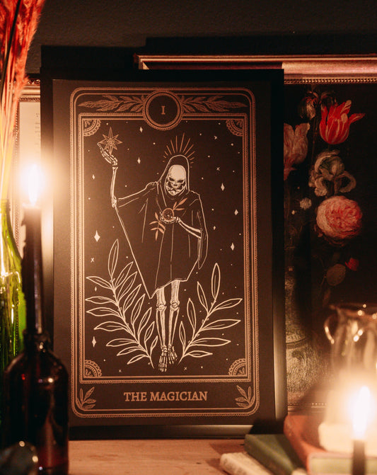 tarot art print in frame on wall of the Magician card from the Marigold Tarot deck by Amrit Brar and 13th Press on altar with candle light and tarot card reading