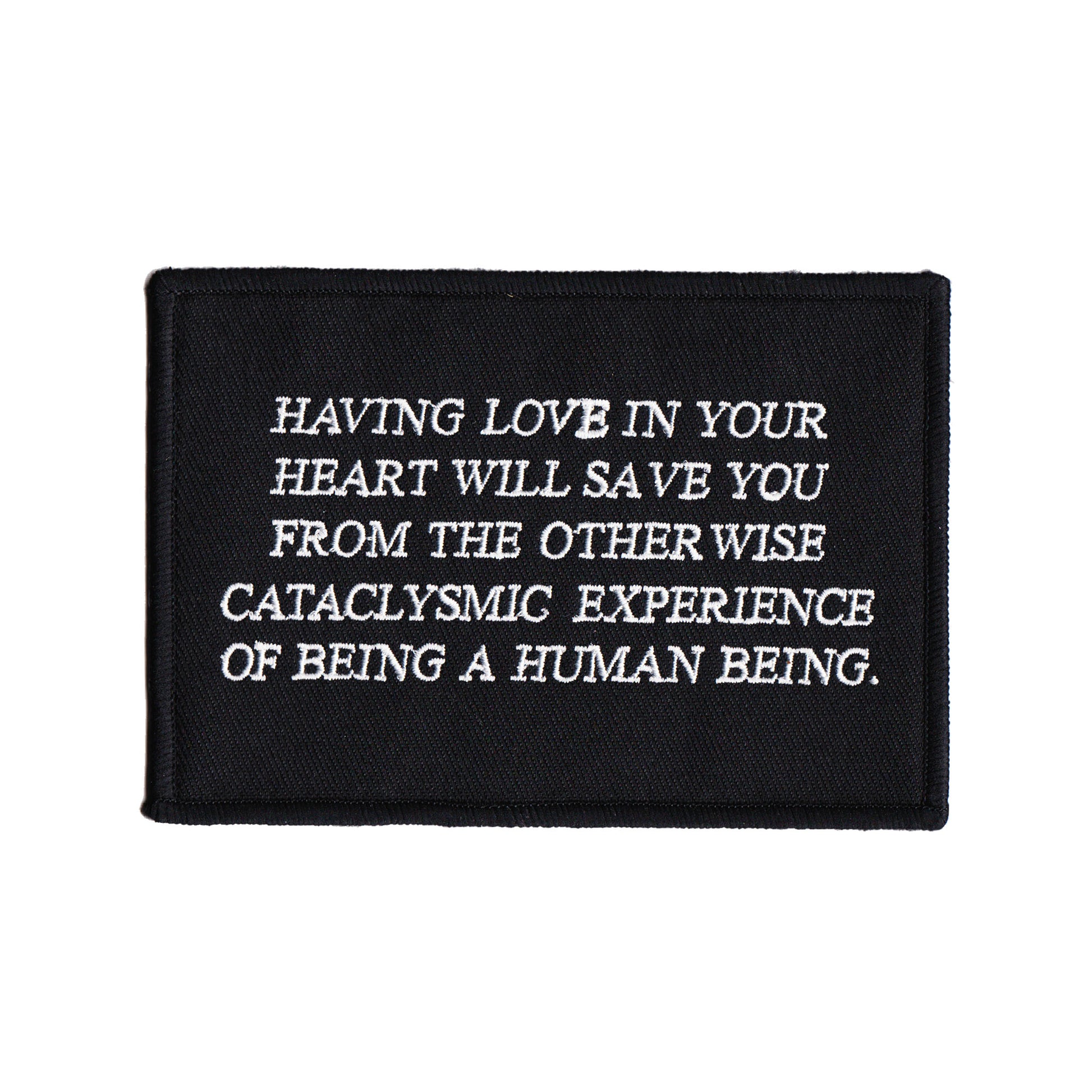 black and white embroidered iron-on patch designed by Amrit Brar and 13th Press. Text reads "having love in your heart will save you from the otherwise cataclysmic experience of being a human being"