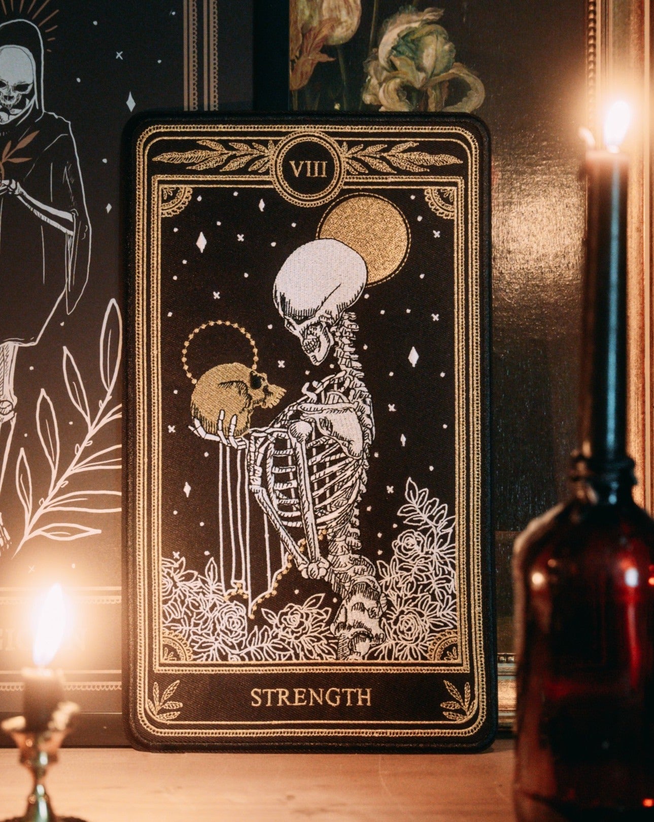 strength tarot card large embroidered back patch with black, gold, and white thread, design from the Marigold Tarot deck by Amrit Brar and 13th Press.