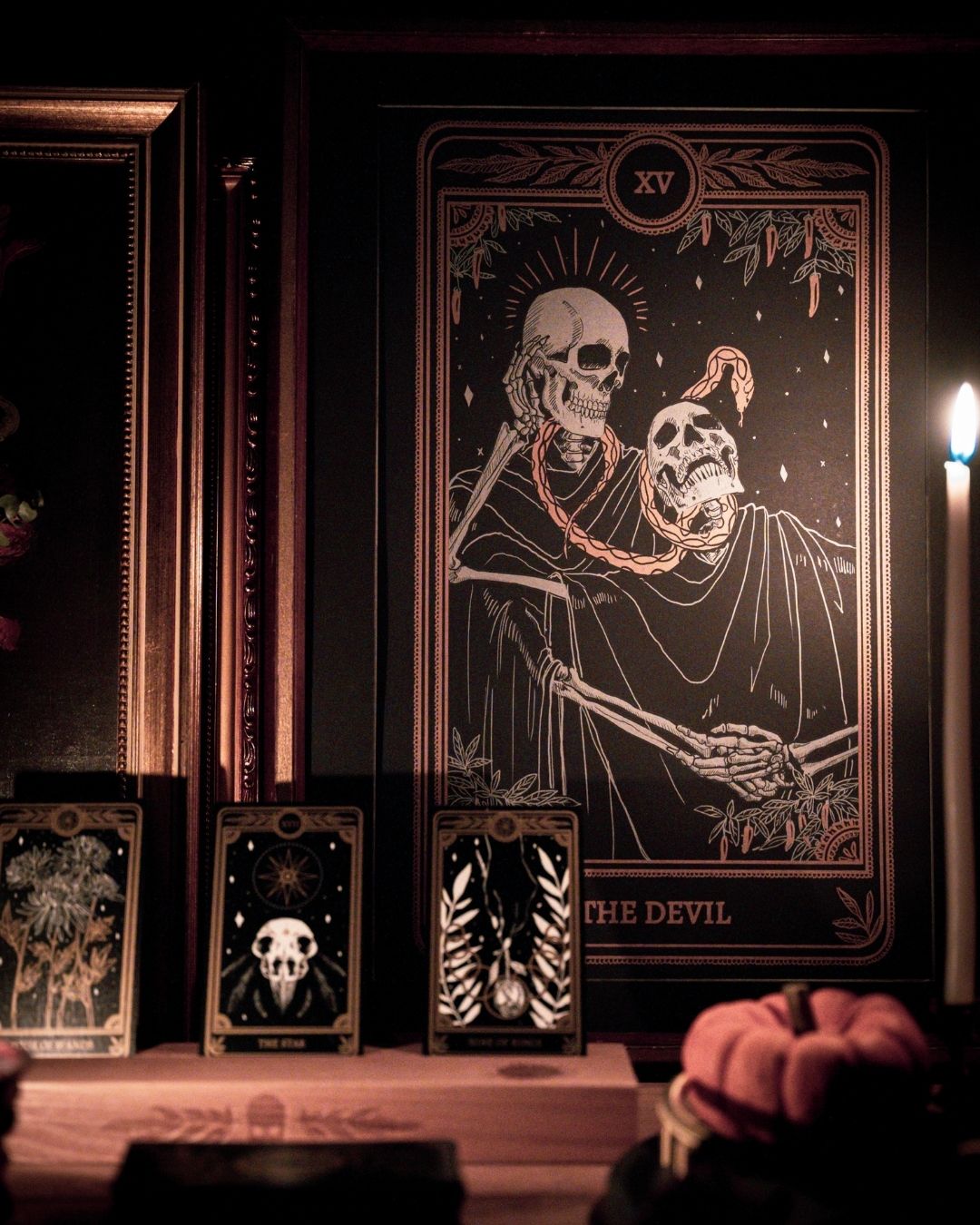 Tarot Devil print from the Marigold Tarot deck by Amrit Brar and 13th Press. With skull and candle decor on altar. Skeleton and serpent. Gold ink