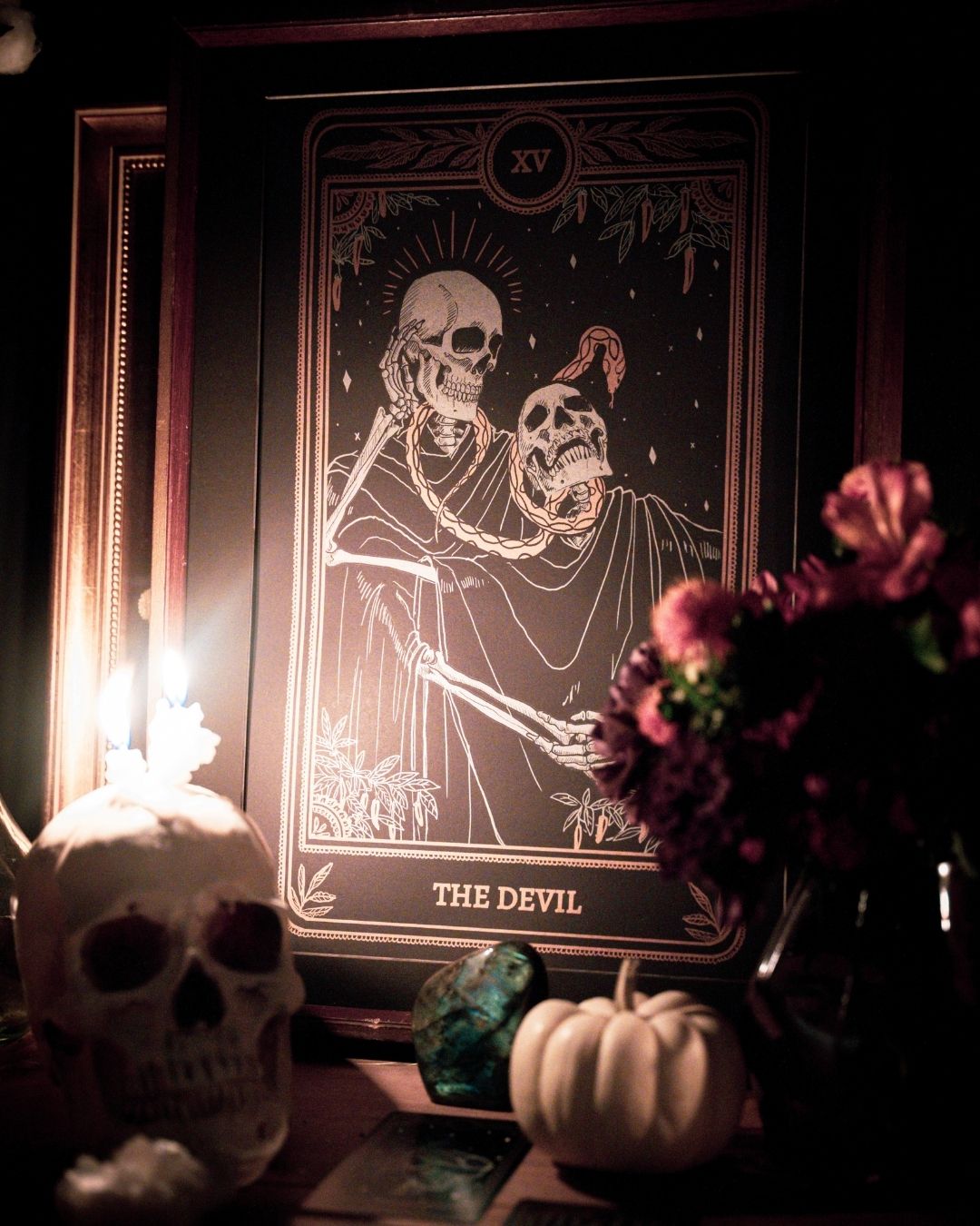 Tarot Devil print from the Marigold Tarot deck by Amrit Brar and 13th Press. With skull and candle decor on altar. Skeleton and serpent. Gold ink