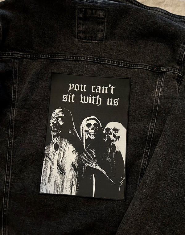 large printed back patch with design of ghouls and slogan you can't sit with us