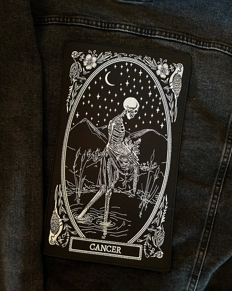 large embroidered back patch of cancer zodiac sign from the mirror oracle deck by amrit brar and 13th press.