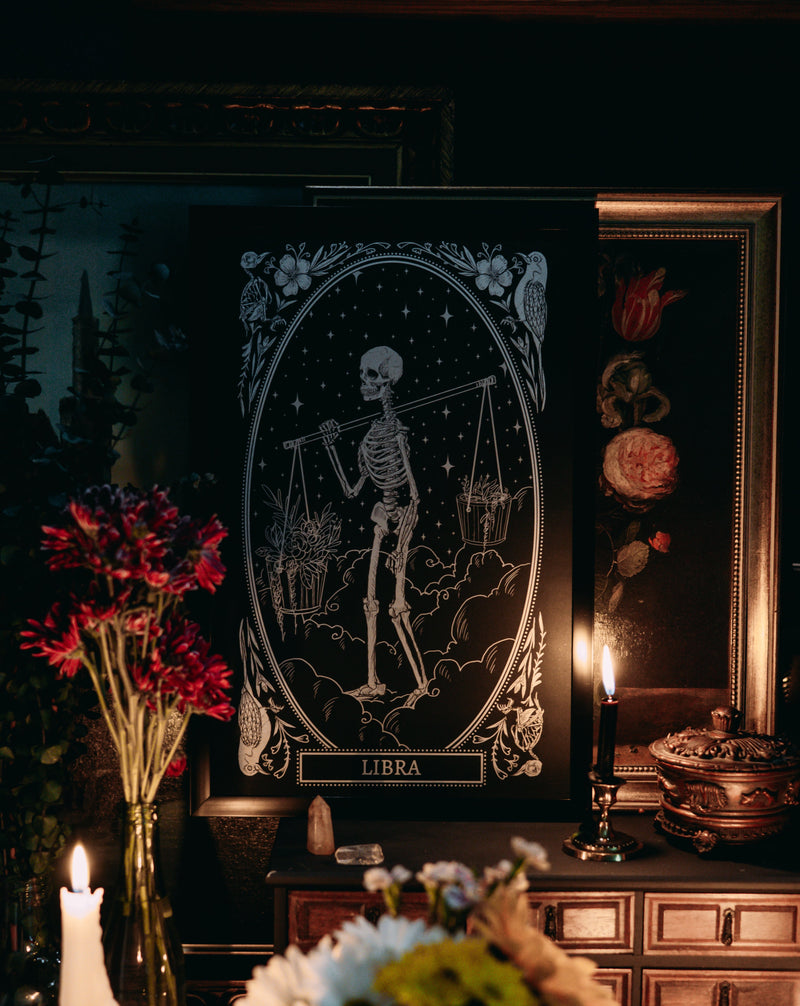 libra zodiac sign design from mirror oracle deck on wood dresser with dried flowers