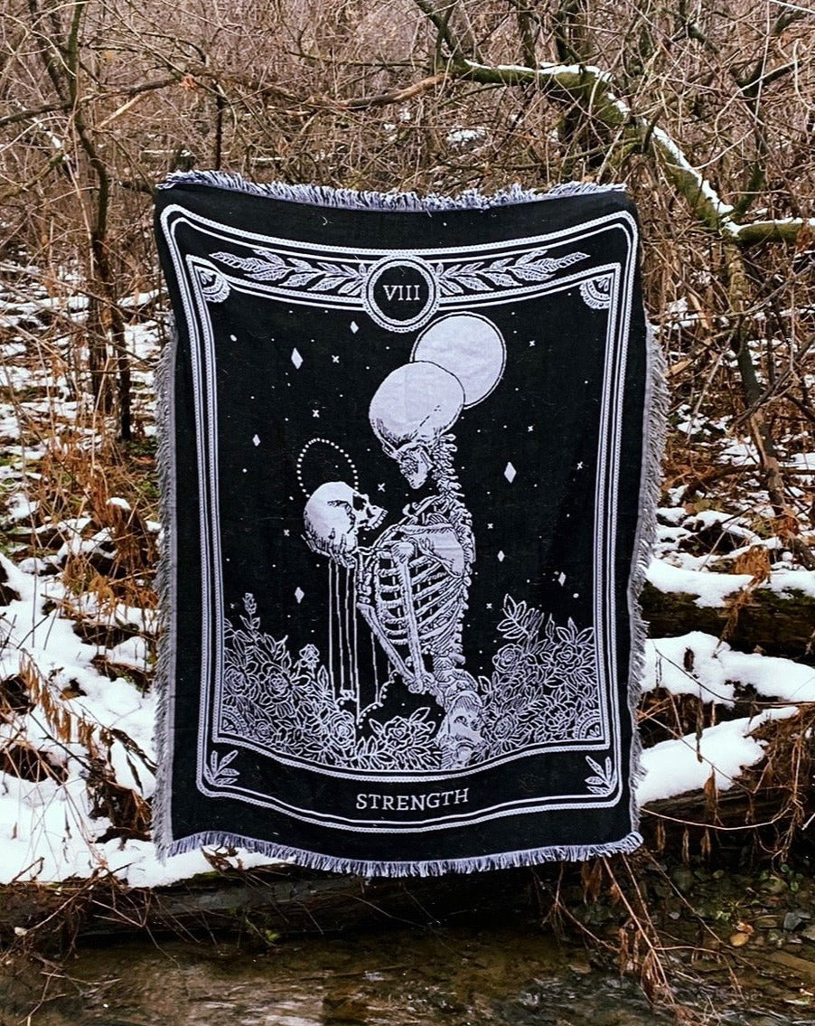 woven tapestry of the Strength tarot card from the Marigold Tarot deck by Amrit brar and 13th Press. 