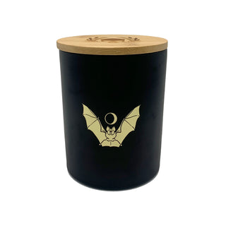 soy wax candle with matte black base and gold foil design of bat and crescent moon. T'erre de hermes scent. 