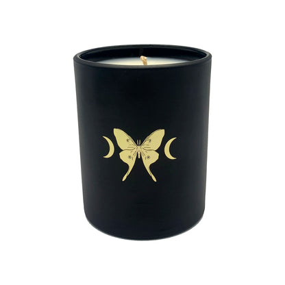 soy wax candle with matte black base and gold foil design of luna moth and crescent moons. Vetiver, cedar, and citrus.