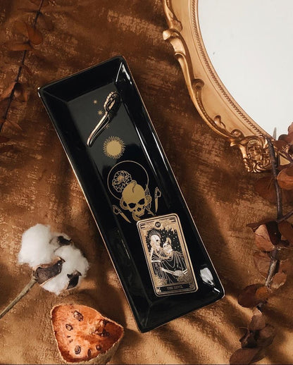 ceramic trinket tray with marigold tarot design in gold ink. Tray for small items. Design is skull with snake and swords.