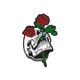 metal hard enamel pin of skull head and red roses designed by Amrit Brar and 13th Press