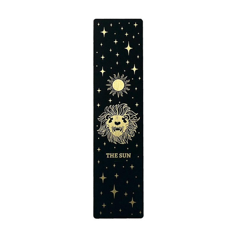 bookmark with the Sun tarot card design. Art from the Marigold tarot deck by Amrit Brar and 13th Press. Black and gold metal bookmark.