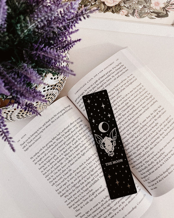 bookmark with moon tarot card design. Art from the Marigold tarot deck by Amrit Brar and 13th Press. Black and silver metal bookmark.