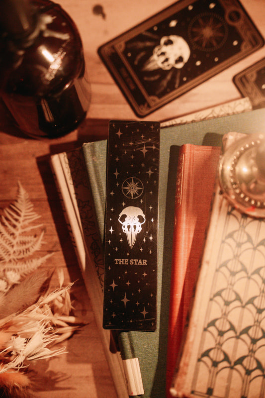 bookmark with the Star tarot card design. Art from the Marigold tarot deck by Amrit Brar and 13th Press. Black and silver metal bookmark.
