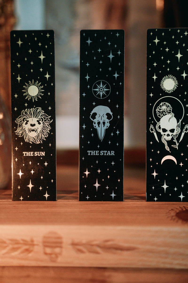 bookmark with the Star tarot card design. Art from the Marigold tarot deck by Amrit Brar and 13th Press. Black and silver metal bookmark.