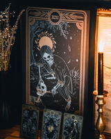 Tarot Death print from the Marigold Tarot Deck and Tarot stand by Amrit Brar and 13th Press on Altar and includes candles and tarot cards on card stand. Skeleton