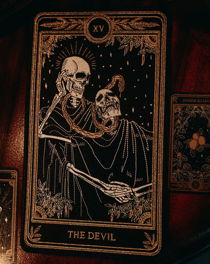 the devil tarot embroidered patch with black, gold, and white thread design from the Marigold Tarot deck by Amrit Brar and 13th Press