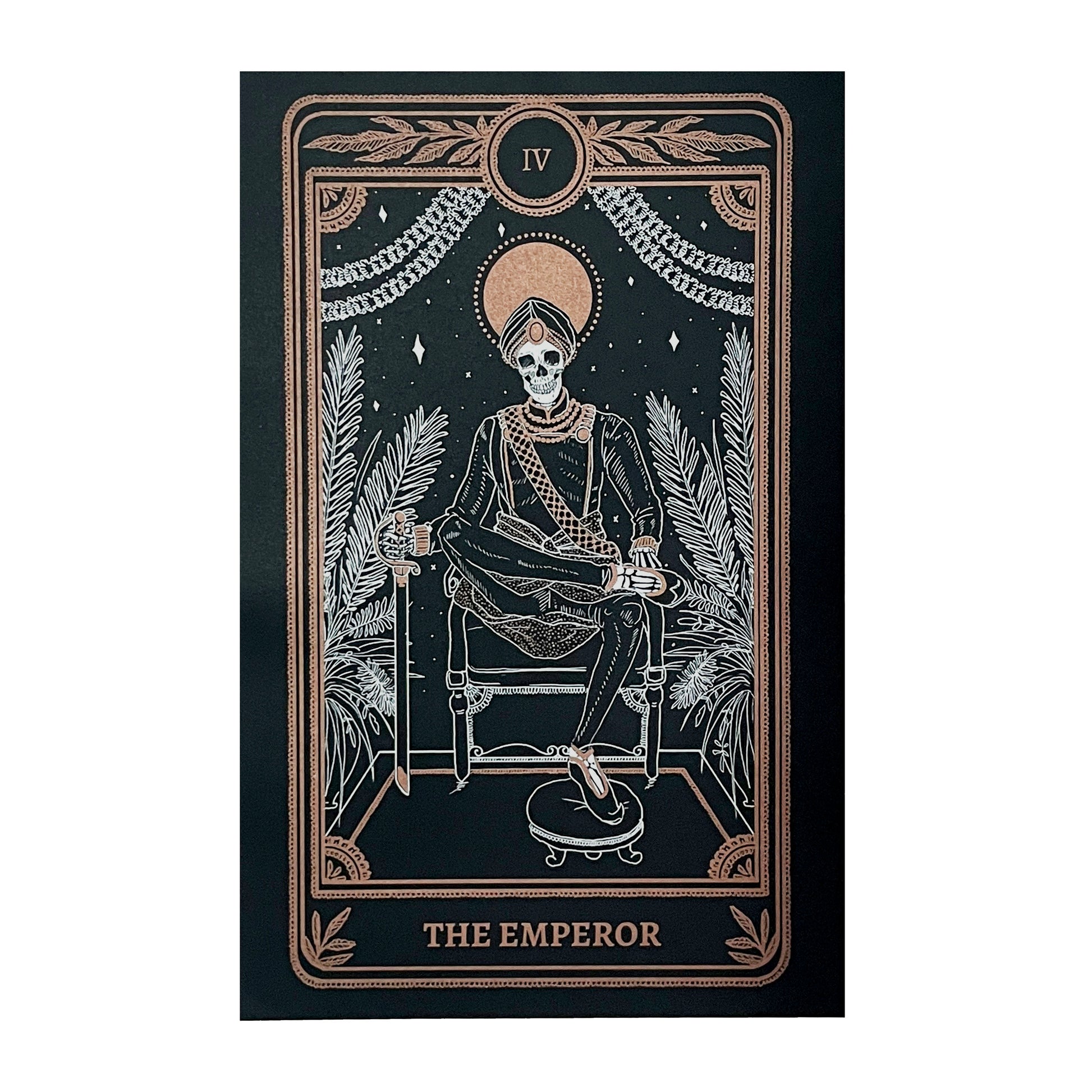 Emperor print with artwork from the Marigold Tarot deck by Amrit Brar and 13th Press on altar stand with foliage and candle light. Black print with white and gold ink of skeleton figure on throne.