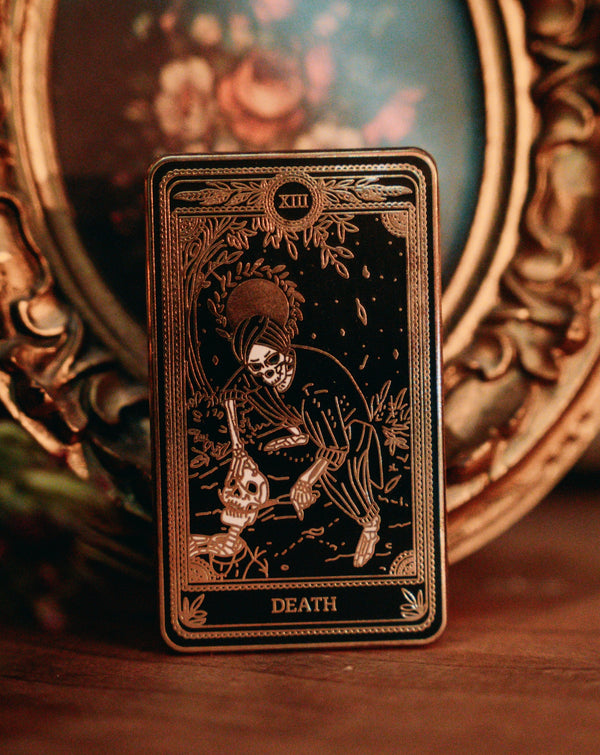 hard enamel pin of Death tarot card from Marigold Tarot deck by amrit brar and 13th Press. Gold and black pin
