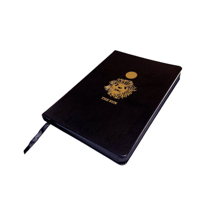 black leather journal with The Sun gold foil designed from the Marigold Tarot deck. Blank journal