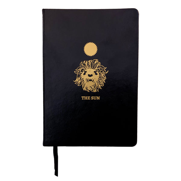 black leather journal with The Sun gold foil designed from the Marigold Tarot deck. Blank journal
