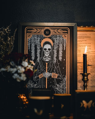 tarot art print with Justice card design from the Marigold Tarot deck by Amrit Brar and 13th Press. Black and gold ink.