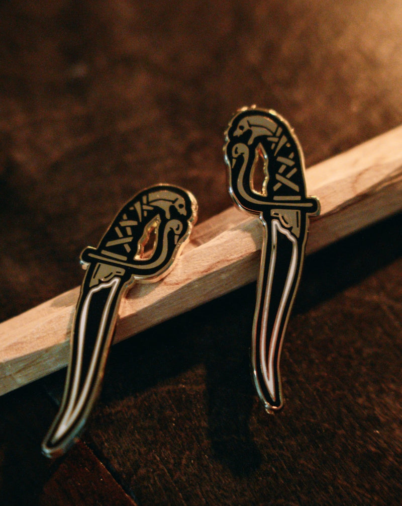 gold and black hard enamel pin set of kirpans, twin blades with serpent heads designed by Amrit Brar and 13th Press