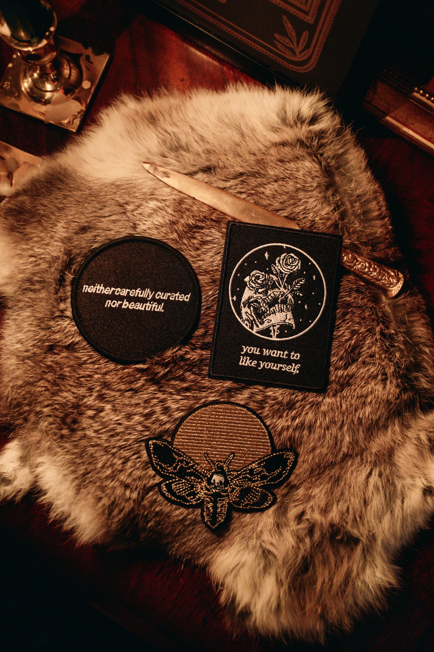 black and white embroidered iron-on patch with skull and rose design by Amrit Brar and 13th Press. Text reads "you want to like yourself".