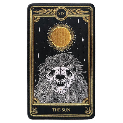 large embroidered patch of sun tarot card design from the Marigold Tarot deck by Amrit Brar and 13th Press. Skeleton of lion figure with sun and stars.