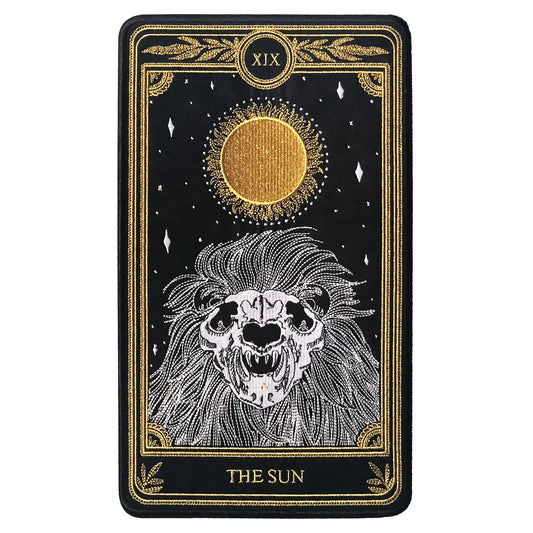 large embroidered patch of sun tarot card design from the Marigold Tarot deck by Amrit Brar and 13th Press. Skeleton of lion figure with sun and stars.