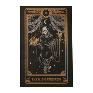 tarot card art print of the High Priestess tarot card from the Marigold Tarot deck by Amrit Brar and 13th Press. Black paper with white and bronze gold ink. Skeleton woman holding pomegranate and flowers.