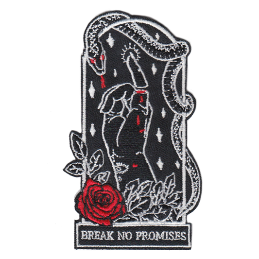 2.5"Wx4"H coffin-shaped embroidered patch featuring an iron-on backing. Patch reads "break no promises." We recommend that you apply a few stitches so the corners do not lift. Designed by Amrit Brar, produced by 13th Press. Embroidered patch, iron-on patch, denim patch, leather patch, biker patch, punk patch