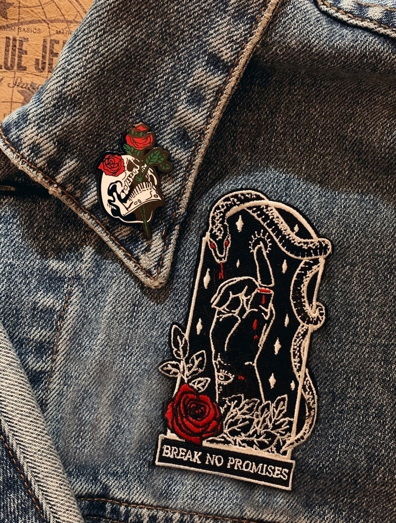 black, white, and red thread embroidered patch of rose, foliage, serpent, and pinky promise designed by Amrit Brar and 13th Press