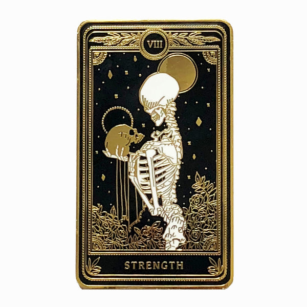 hard enamel pin of strength tarot card from the Marigold Tarot deck by Amrit Brar and 13th Press. Black pin with gold and white ink. Pin for jackets and bags