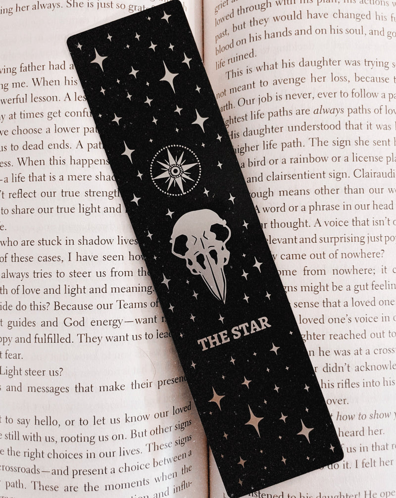 bookmark with the Star tarot card design. Art from the Marigold tarot deck by Amrit Brar and 13th Press. Black and silver metal bookmark.