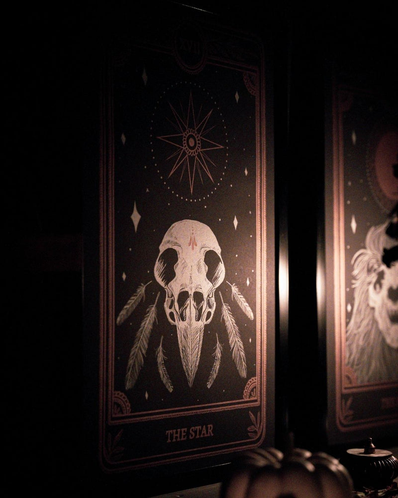 Tarot The Star print from the Marigold Tarot deck by Amrit Brar and 13th Press. With skull and candle decor on altar. Skeleton and feathers. Gold inkTarot The Star print from the Marigold Tarot deck by Amrit Brar and 13th Press. With skull and candle decor on altar. Skeleton and pumpkins. Gold ink