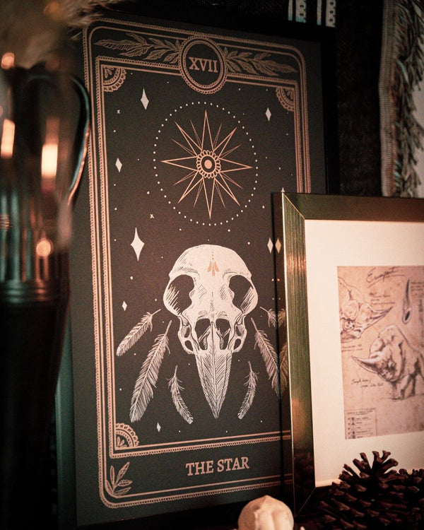 Tarot The Star print from the Marigold Tarot deck by Amrit Brar and 13th Press. With skull and candle decor on altar. Skeleton and feathers. Gold ink