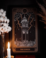 Tarot The Tower print from the Marigold Tarot deck by Amrit Brar and 13th Press. With skull and candle decor on altar. Gold ink