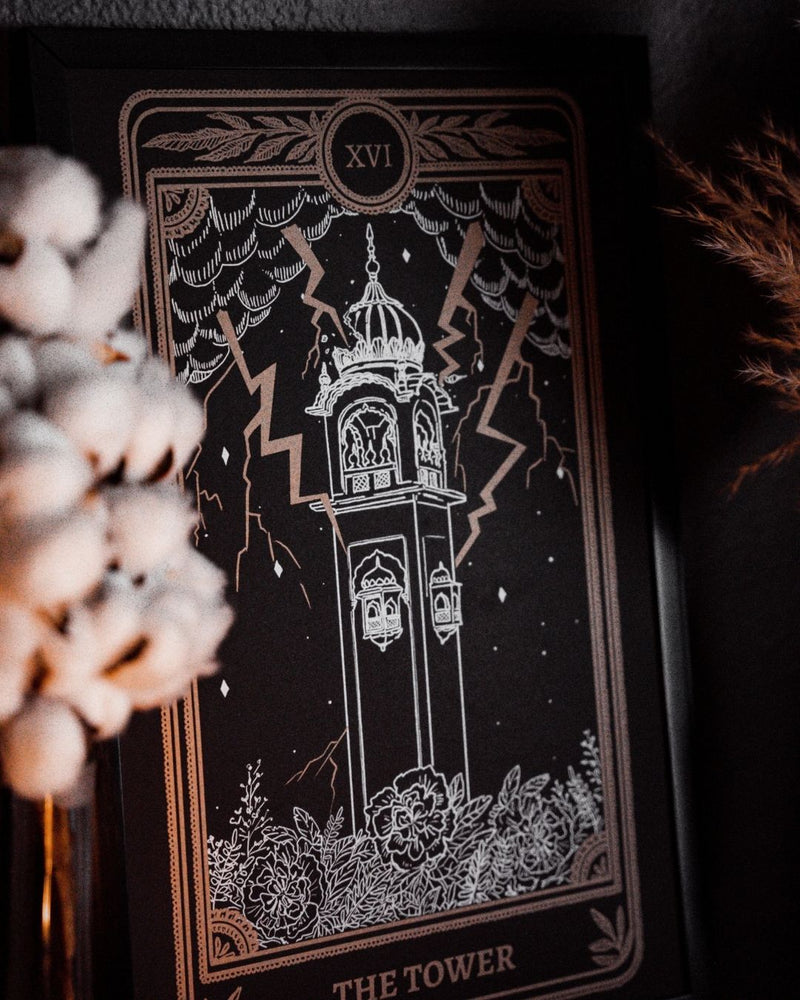 Tarot The Tower art print from the Marigold Tarot deck by Amrit Brar and 13th Press. With skull and candle decor on altar. Gold ink