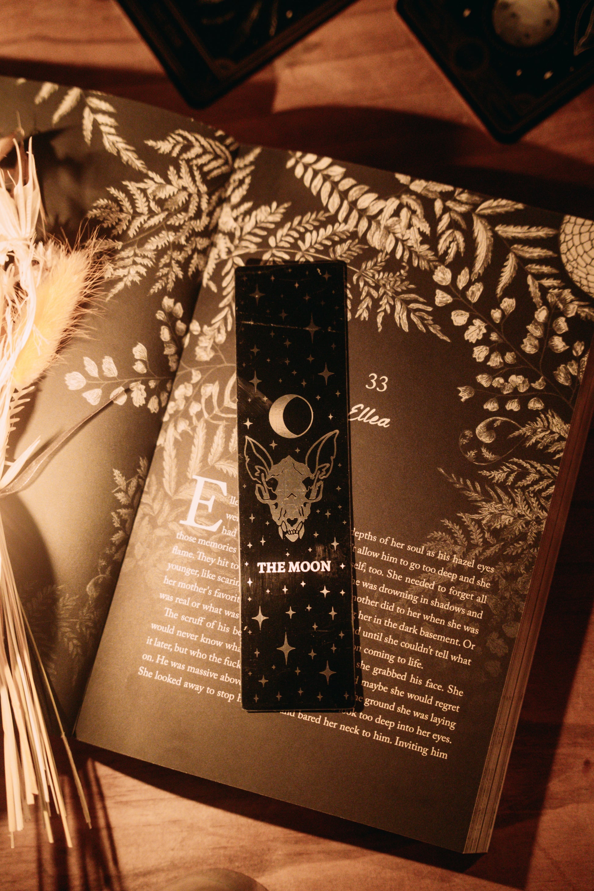 bookmark with moon tarot card design. Art from the Marigold tarot deck by Amrit Brar and 13th Press. Black and silver metal bookmark.