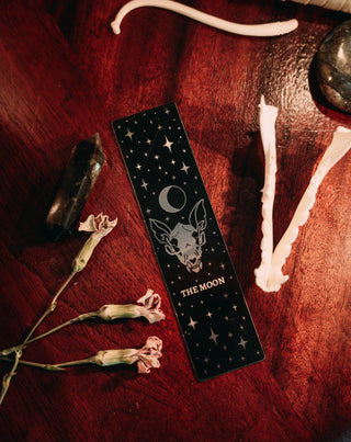 bookmark with moon tarot card design. Art from the Marigold tarot deck by Amrit Brar and 13th Press. Black and silver metal bookmark.