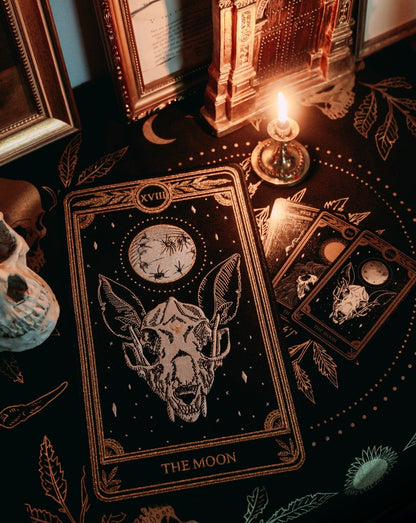 large embroidered back patch of the Moon design from the Marigold Tarot by Amrit Brar and 13th Press on altar with tarot cloth, tarot reading, skull, and candle.