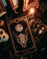 large embroidered back patch of the Moon design from the Marigold Tarot by Amrit Brar and 13th Press on black denim jacket. Resting on altar with tarot cloth, skull, candle light and tarot reading.