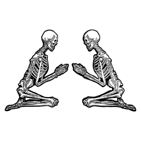 metal hard enamel pin set of two skeletons in prayer position designed by Amrit Brar and 13th Press